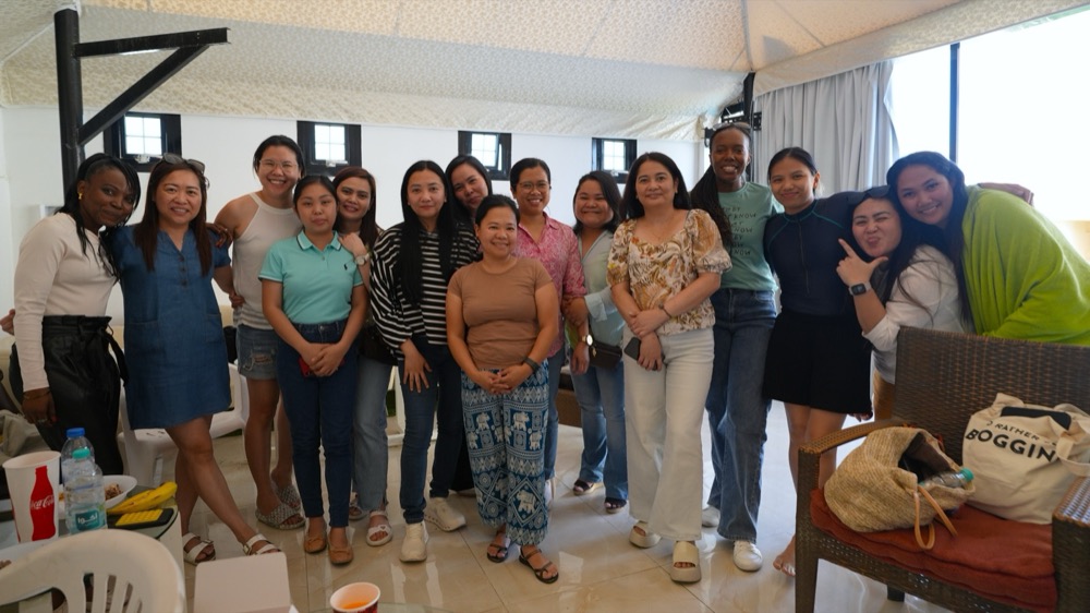 A group from Koinonia smiling together indoors