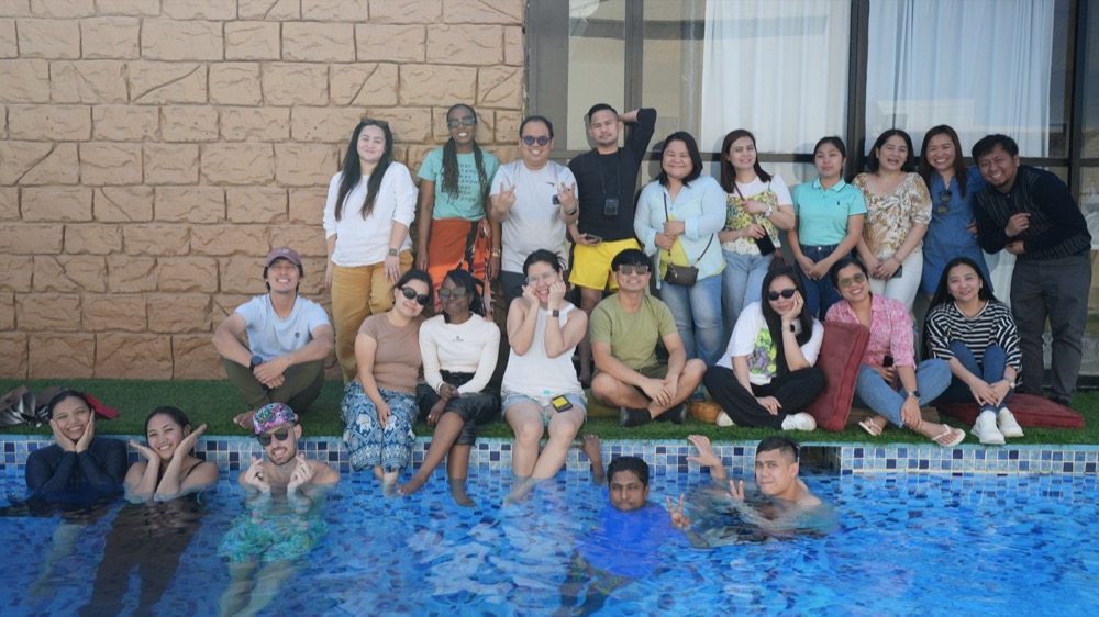 The Koinonia family relaxing together by the pool